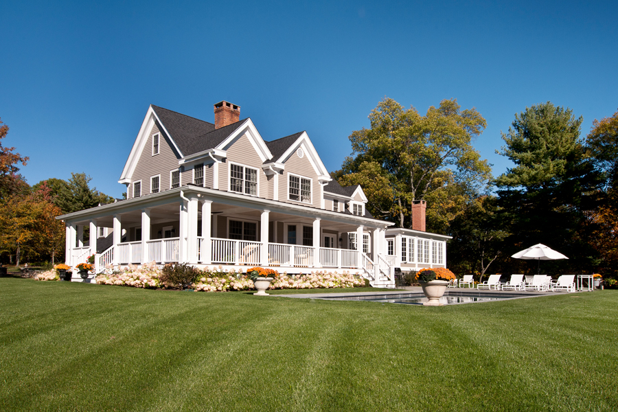 Colonial Farmhouse architect wrap-around covered porch inground pool Sloan Architects